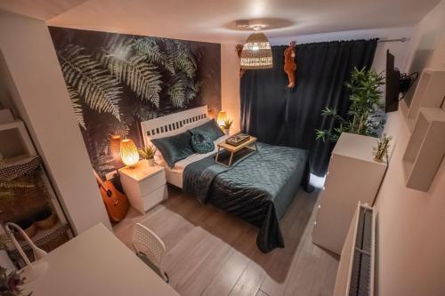 an overhead view of a bedroom with a bed and plants at Forest Work & Relax Accommodation in Overstone