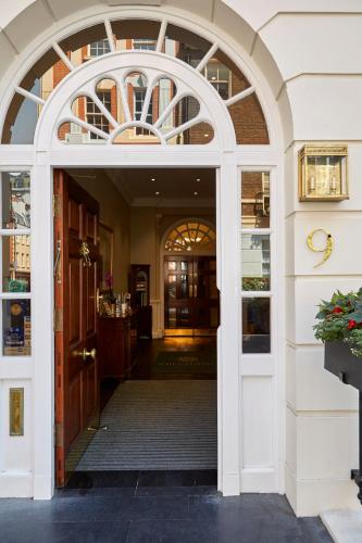 an entrance to a building with an arch doorway at 9 Hertford Street - 4 Stars VisitEngland in London