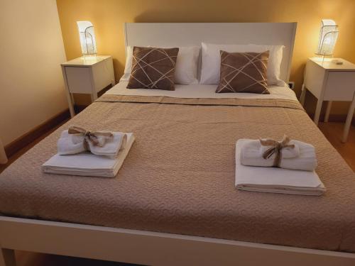 a bedroom with a large bed with towels on it at La Perla Di Noto in Noto