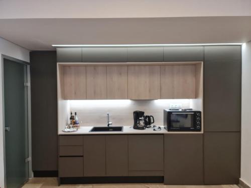 a kitchen with a sink and a microwave at Sarri Appartments in Amoudara Herakliou