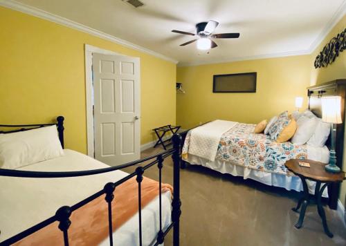 a bedroom with two beds and a ceiling fan at Barren Breeze Bed and Breakfast in Lucas