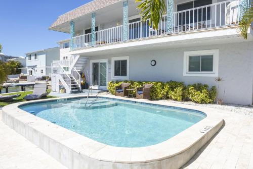 a swimming pool in front of a house at Waterfront & Pool B Star5Vacations in St. Pete Beach