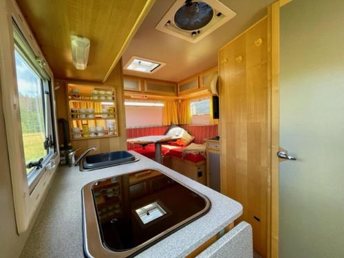 a kitchen and living room in a train car at Alte Mühle Börfink in Börfink