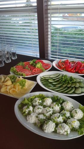 a table with plates of food on a table at Aqua Hotel in Polkowice