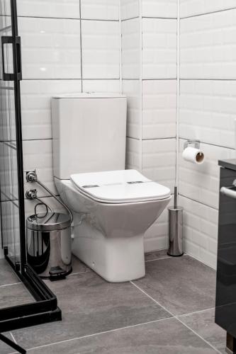 a bathroom with a white toilet in a room at Comfort Center Suit Hotel in Edirne