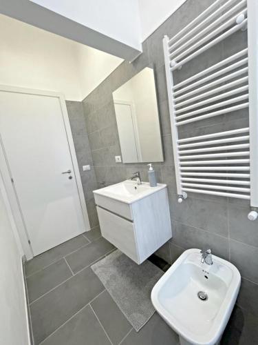 a bathroom with a white sink and a mirror at Pit stop Ciampino Station in Ciampino