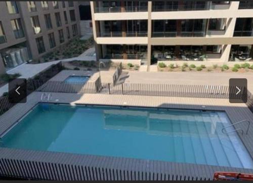 a large swimming pool in front of a building at Apart Hotel in downtown Santiago Historic Center in Santiago