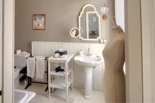 a white bathroom with a sink and a toilet at B&B In Bruges in Bruges