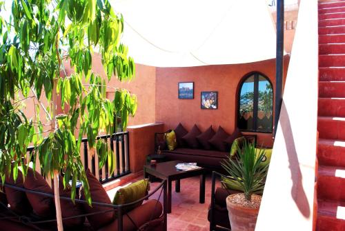 a living room with a couch and a table at Riad Al Mendili Private Resort & Spa in Had Abdallah Rhiat