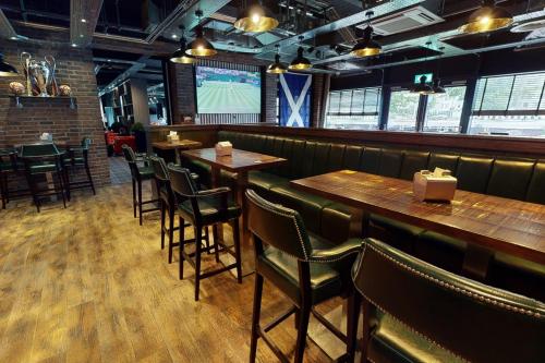 a dining room with wooden tables and chairs at Village Hotel Aberdeen in Aberdeen