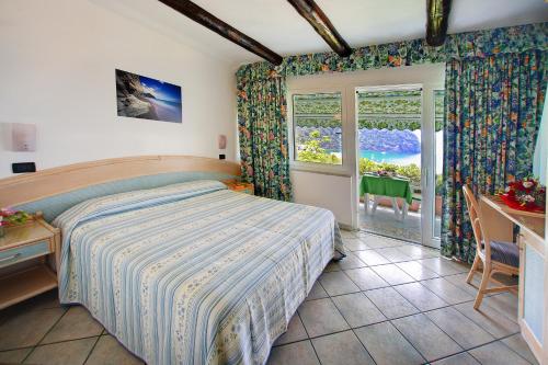 En eller flere senge i et værelse på Appartamenti Casa del Sole