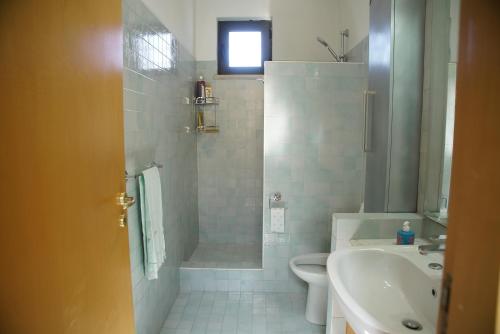 a bathroom with a shower and a sink and a toilet at La casa di Clelia in Cercola