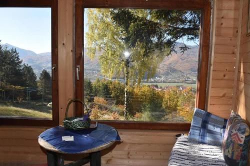 a room with a table and a window with a view at Seosko domacinstvo Imanje Medojevic in Mojkovac