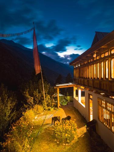 a building with animals standing outside of it at night at Folktales Residency in Saturang