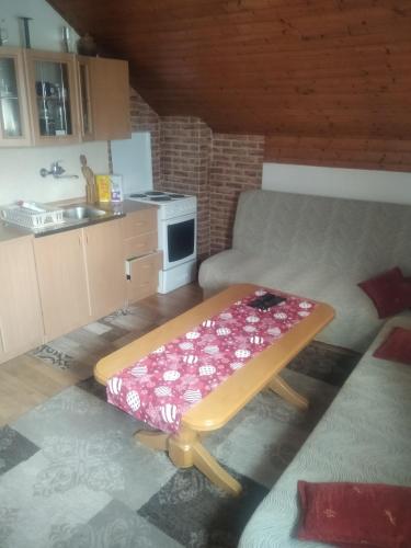 a living room with a table and a kitchen at Vinara Kupres in Kupres