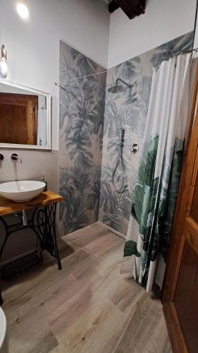 a bathroom with a shower curtain and a sink at Casina di Alice in Vinci