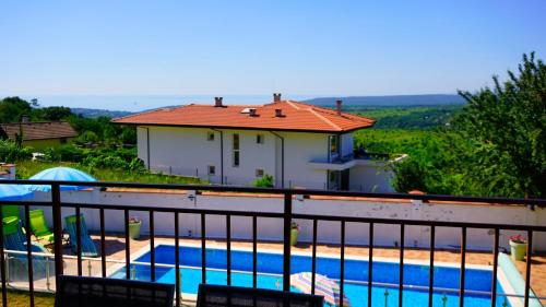 a house with a swimming pool on a balcony at Вила Сънрайз - Villa Sunrise in Varna City