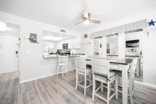 a kitchen and dining room with a table and chairs at Ocean Village Club J24 in Saint Augustine