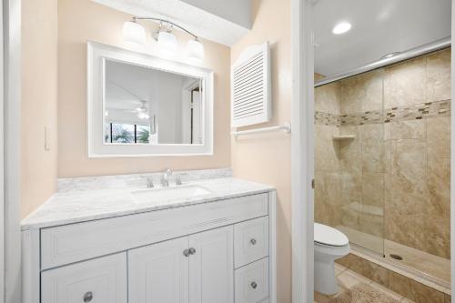 a white bathroom with a sink and a shower at Ocean Village Club P32 in Saint Augustine