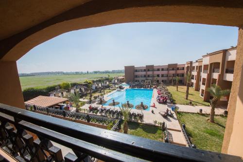 a view of the pool from the balcony of a resort at Zalagh Kasbah Hotel & Spa in Marrakech