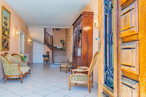 a hallway with chairs and a staircase in a house at Ostal Cassinia in Cassagne