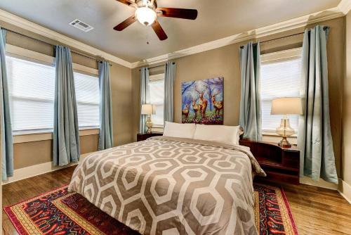 a bedroom with a bed and a ceiling fan at Boho Bungalow-walk to Plaza District can sleep 8 in Oklahoma City