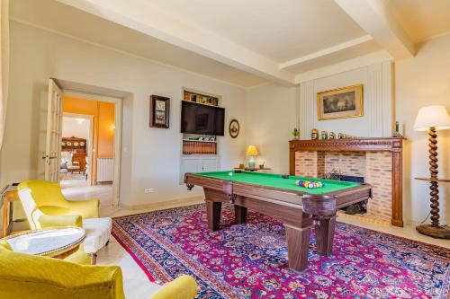 a living room with a pool table and a fireplace at Ostal Cassinia in Cassagne
