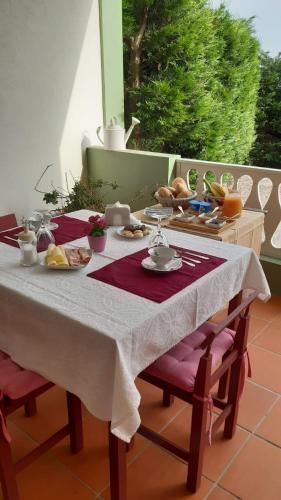 a table with a white table cloth and food on it at Casa Vila Palmeira in Fermelã