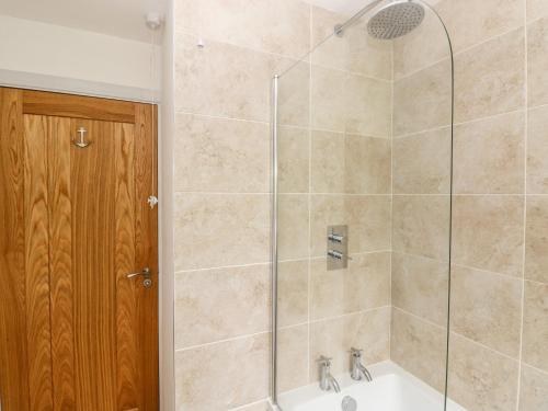 a bathroom with a shower and a sink at Chalfonts Cottage in Haverfordwest