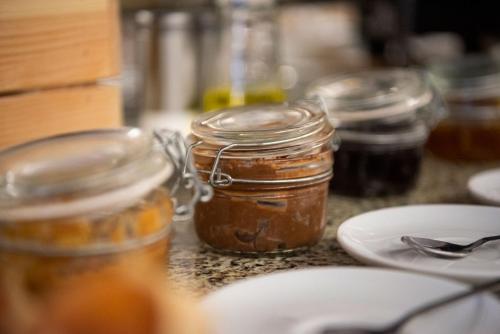 a group of jars of honey on a counter at Hotel Rural Solar das Arcadas in Ponte de Lima