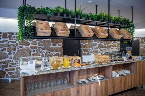 a buffet with shoes and drinks on a counter at Hotel Rural Solar das Arcadas in Ponte de Lima