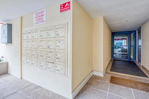 a hallway with a door in a building at Appartement Thiers - Welkeys in Antibes