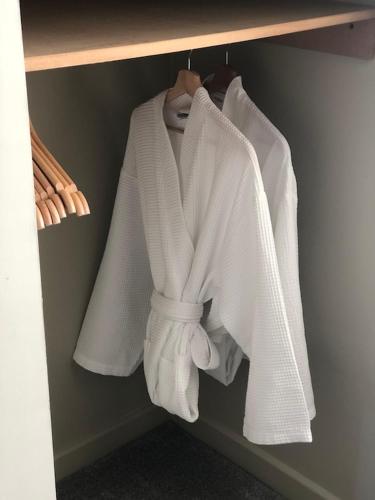 a group of white towels hanging on a rack at the house@glenbarr in Glenbarr