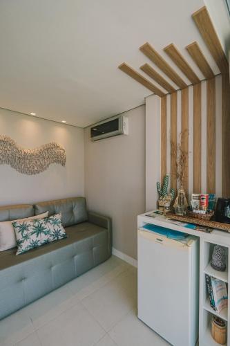 a living room with a couch and a counter at Hotel Sete Ilhas in Florianópolis