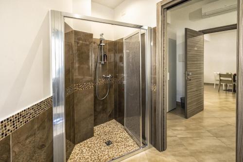 a shower with a glass door in a bathroom at La dimora dei ricci in Santo Stefano di Camastra