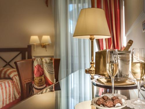 a table with a lamp and a plate of food on it at Palazzo Cardinal Cesi in Rome