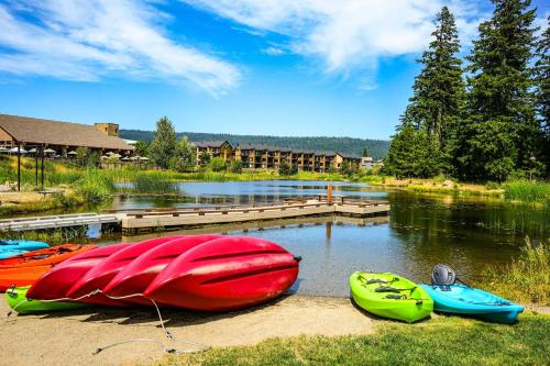 a group of boats sitting on the shore of a lake at Suncadia Penthouse with Mountain and River Views! in Cle Elum
