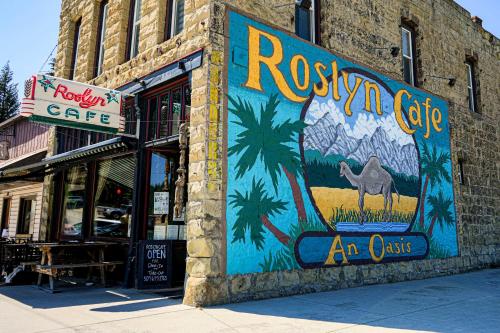 a building with a painting on the side of it at Suncadia Penthouse with Mountain and River Views! in Cle Elum