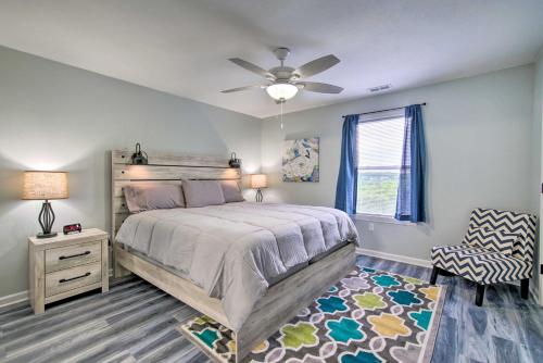 a bedroom with a bed and a ceiling fan at 5 Mi to Branson Strip! Cozy Condo with Mtn Views in Branson