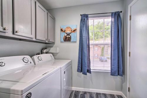 a laundry room with a washing machine and a window at Cozy Branson Condo with Balcony and Mountain Views in Branson