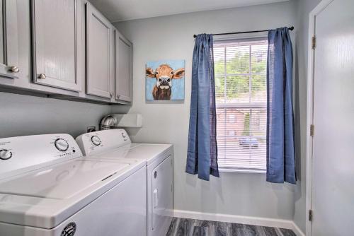 a laundry room with a washing machine and a window at 5 Mi to Branson Strip! Cozy Condo with Mtn Views in Branson