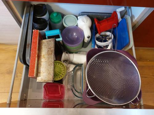 a drawer filled with various kitchen utensils and a strainer at Italian Apartment with Hot Tub in Arabba