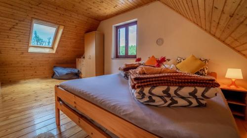 a bedroom with a bed in a log cabin at Planinaki Raj in Lokve