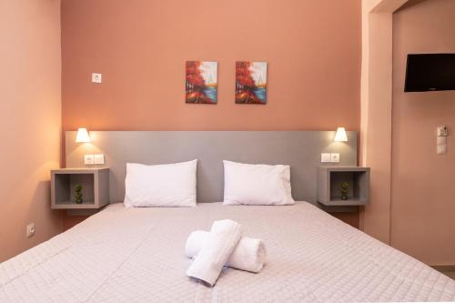 a bedroom with a bed with two towels on it at Aza Studios in Laganas