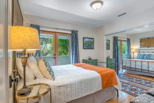 a bedroom with a bed and a large window at Cedar Oasis in Ventura