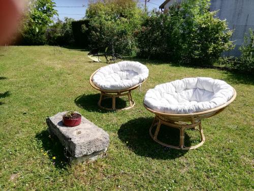 two beds sitting on the grass in a yard at Chambre privée calme,campagne, piscine,étape,déplacement pro,abri moto vélo,parking in Vaux-sur-Vienne
