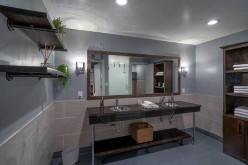 a bathroom with two sinks and a mirror at Contemporary flat at The Maddox in Nashville