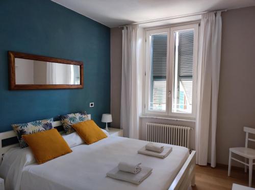a bedroom with a large white bed with a window at Santa Marta Rooms - Via Roma 23 in Vernazza
