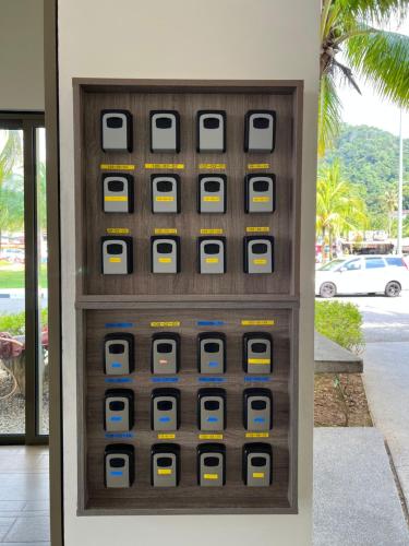a vending machine filled with boxes on a wall at By The Sea Beachfront Designer Suites Penang - Managed by Art of Tree in Batu Ferringhi