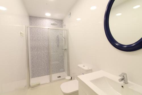 a bathroom with a shower and a toilet and a sink at Fisherman's Townhouse at Old Town in Albufeira